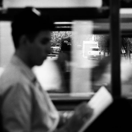 Cover of Fall 2025 Tulane Review is an excerpt of "On the Streetcar" by Ali Saunders: a black and white photograph of a person reading on a train